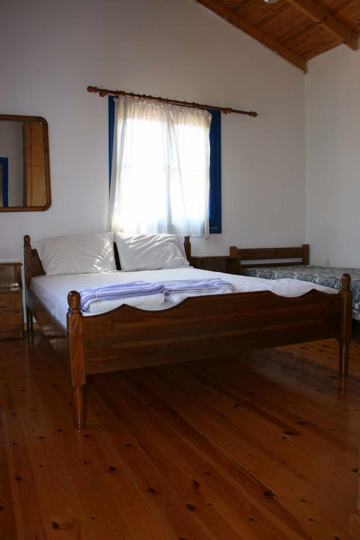 Double bedroom with wooden floor and roof